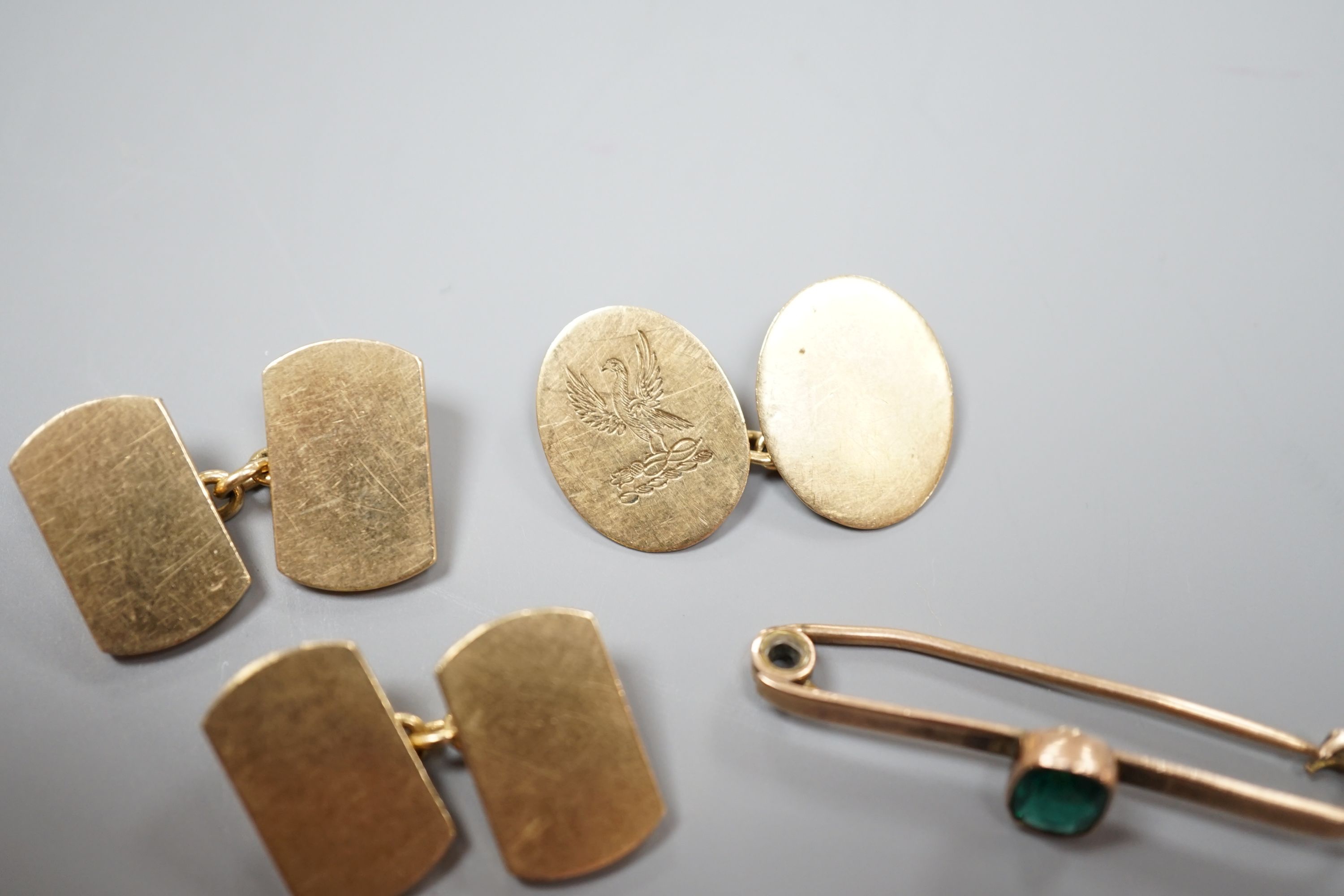 A pair of 9ct gold cufflinks, one other single 9ct gold cufflink and a 9ct and gem set bar brooch